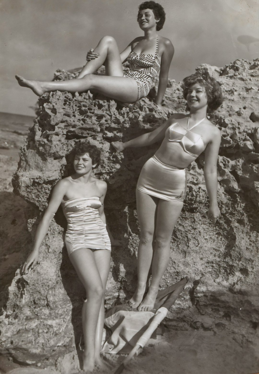 Bernice Kopple, Photograph used in article 'Bonny Scot Beach Girl', Australia,1950s by Watch Brands grayscale photo of three women standing and sitting on rocks